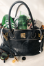 Black handbag with green bottles, sunglasses, and other items on a white background